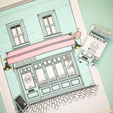 Crumbs & Doilies Tea Towel features a cute Soho shop illustration, 100% cotton, 50x75cm, absorbent and machine washable.